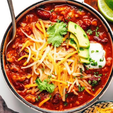 Pumpkin chili in a bowl with toppings.
